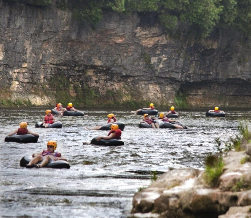 Travellers floating the Grand River white water in tubes at Elora Gorge, Ontario