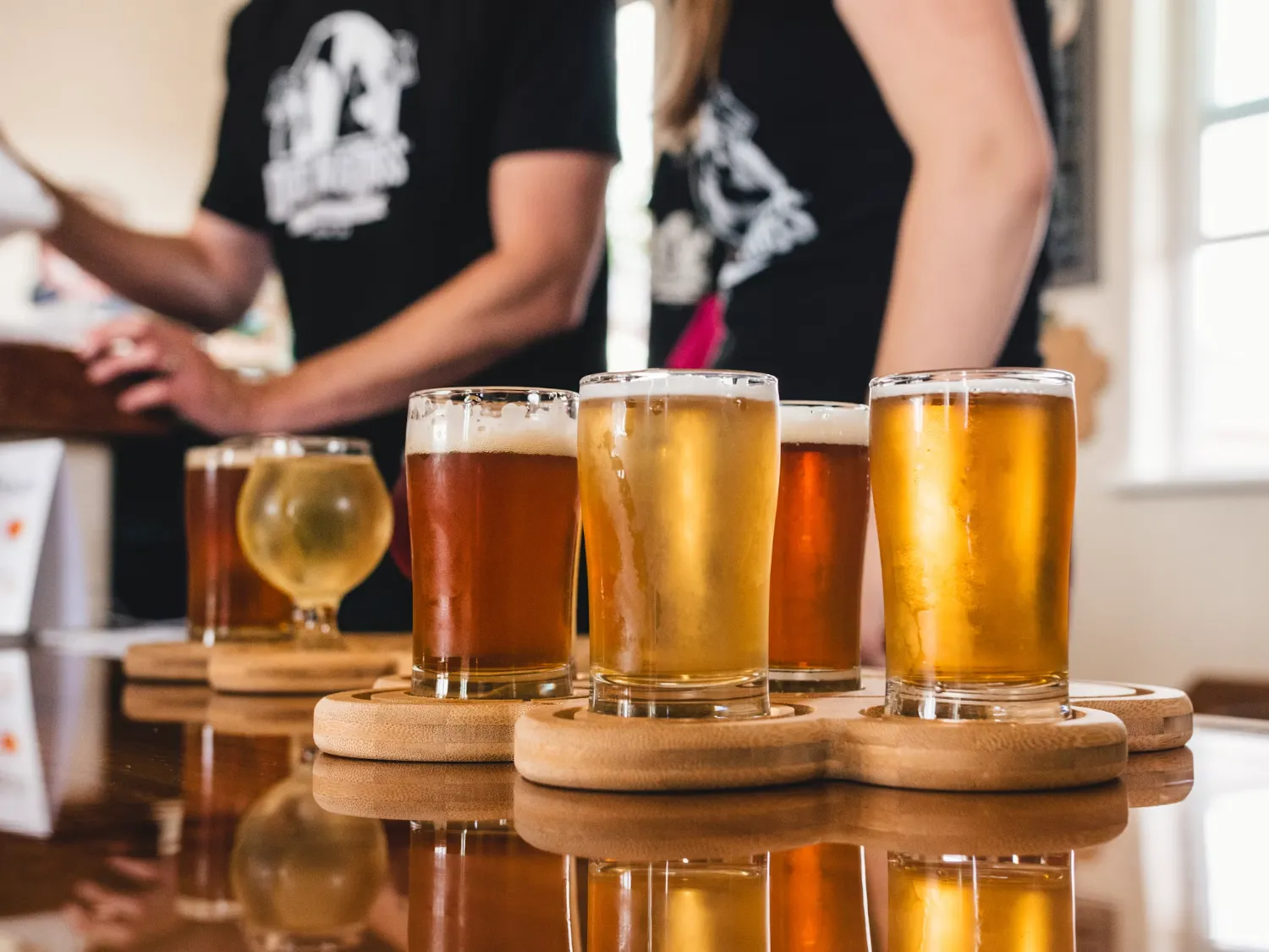 Flight of craft cider glasses on a wooden table at an Ontario cidery